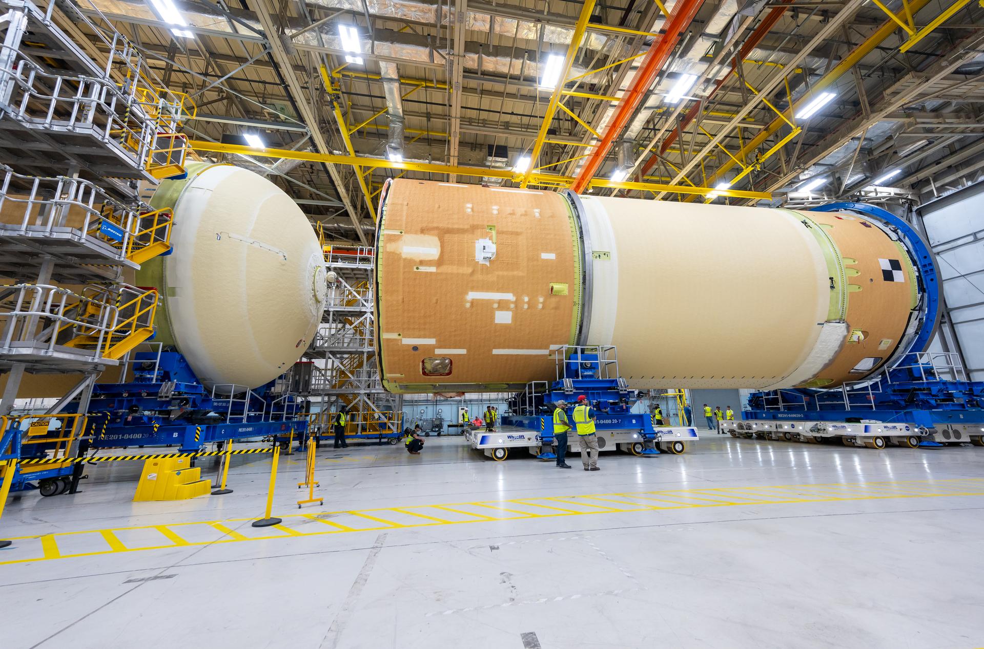 Move crews at NASA’s Michoud Assembly Facility in New Orleans, lift the forward-joined flight hardware for the agency’s SLS (Space Launch System) rocket out of a stacking cell in the vertical assembly building on Dec. 19, 2025. The forward join, which consists of the intertank, liquid oxygen tank, and forward skirt, will be used on the core stage slated for NASA’s Artemis III mission. Teams moved the flight hardware from the cell and set it atop self-propelled mobile transporters. The article was brought to the factory’s final assembly area on Dec. 27, 2025 where it will be mated to the core stage’s previously joined liquid hydrogen tank and undergo further integration.    The core stage, along with its four RS-25 engines, produce more than two million pounds of thrust to help launch NASA’s Orion spacecraft, astronauts, and supplies beyond Earth’s orbit and to the lunar surface for Artemis.